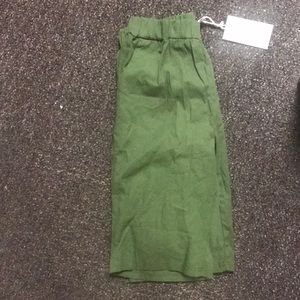 Green knee-length shorts. 95% cotton 5% spandex.